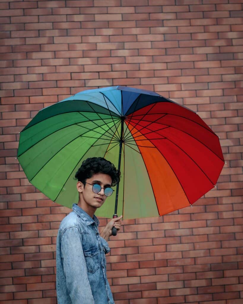 a man holding a colorful umbrella